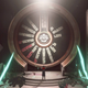 Jun stands in front of a puzzle vault door.